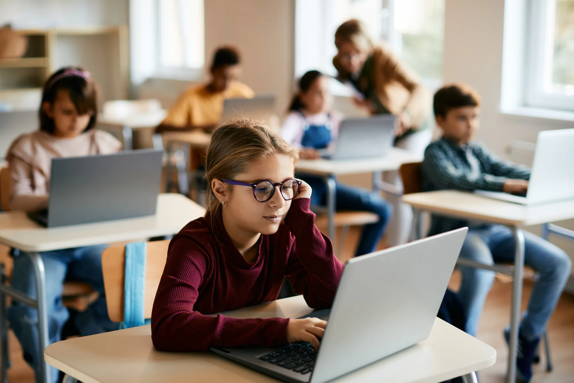 Students working on laptops in a classroom