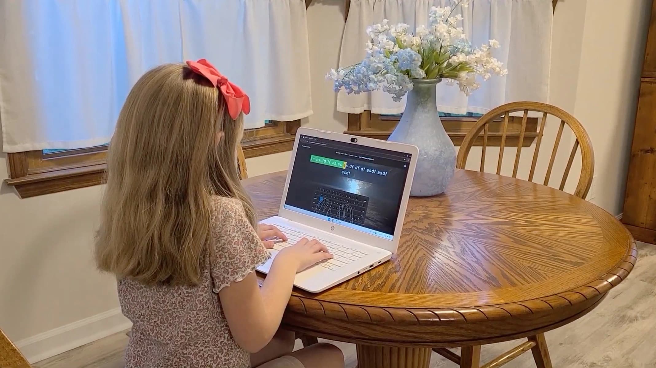 A girl typing Scripture with Typed in Faith